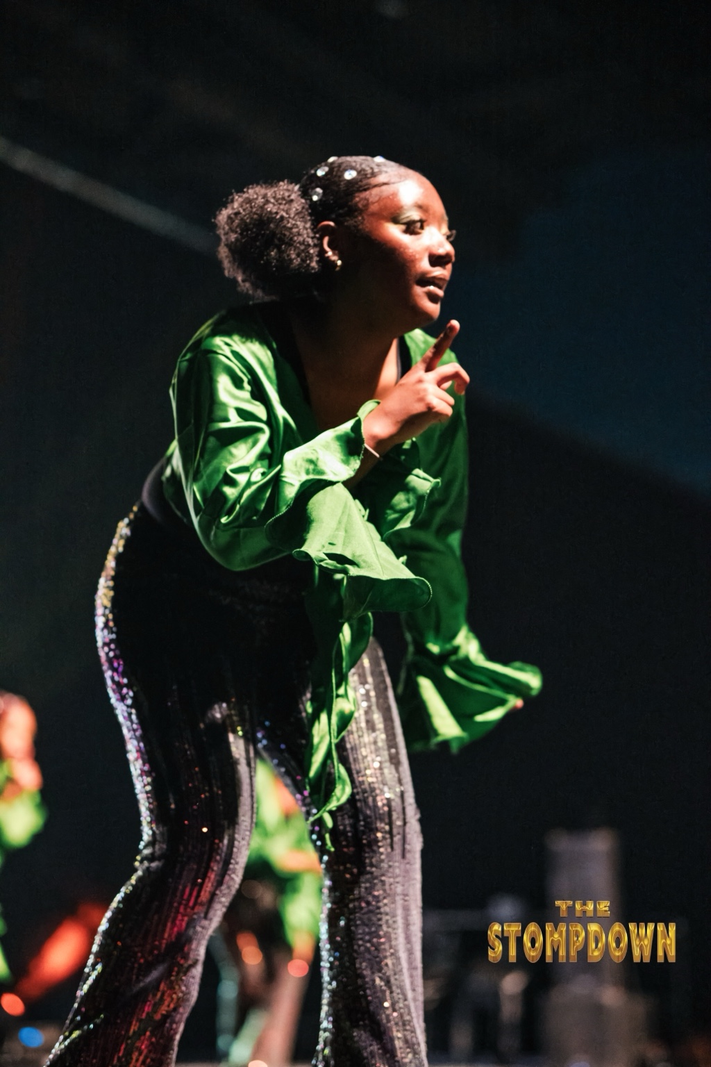 Young performer in green delivering a step routine