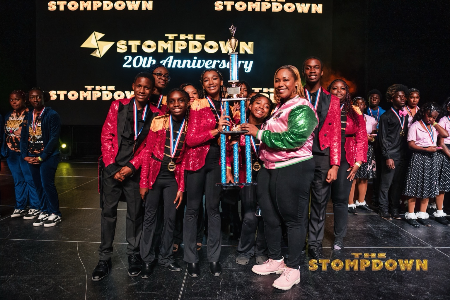 Team receiving a championship trophy on stage